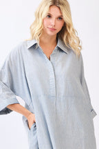 Woman wearing a striped blue and white shirt dress on a white background