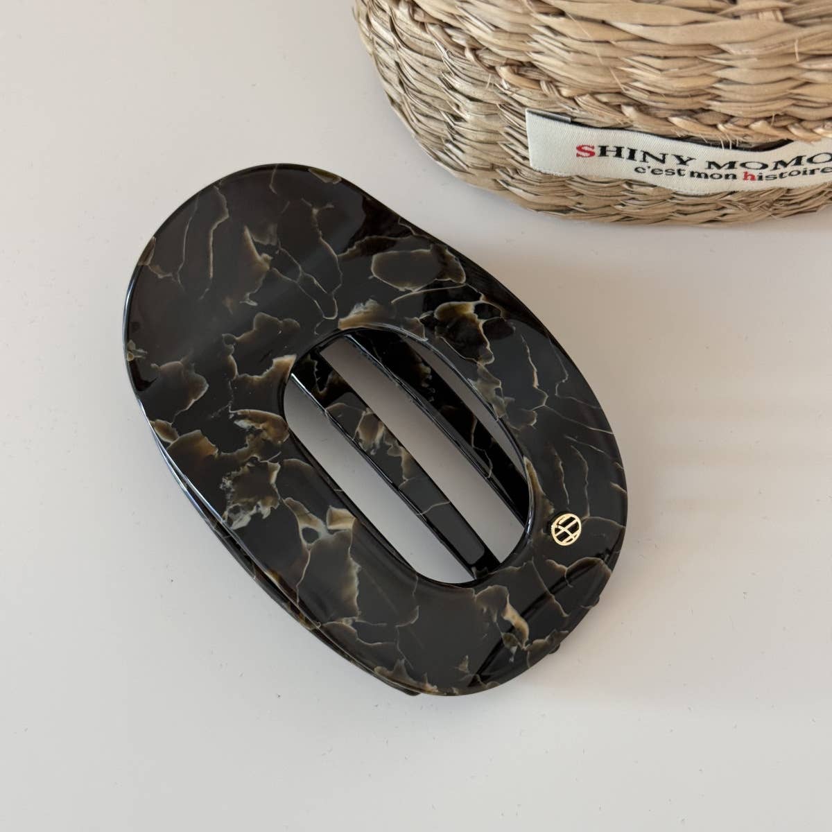 Black and tan marbled hair clip on a light surface