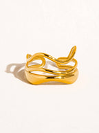 Gold tone geometric abstract ring against a white background