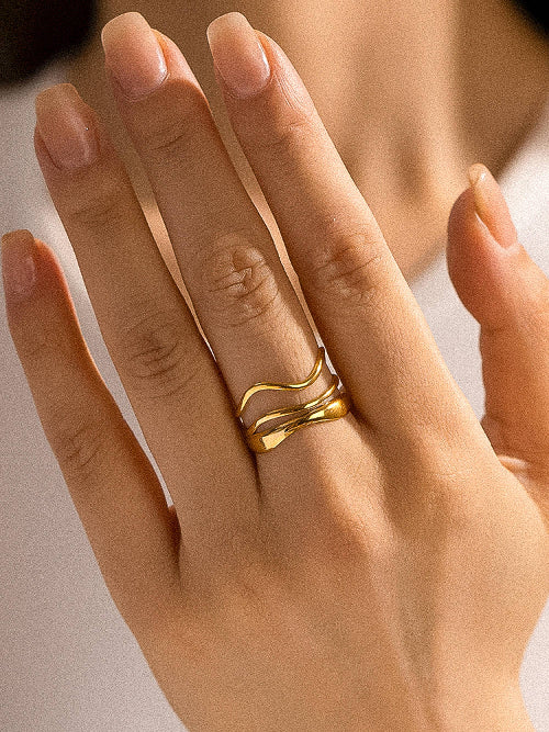 Woman wearing a gold tone geometric abstract ring 