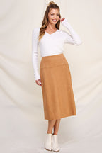 Woman wearing camel a-line microsuede midi skirt with white top on a white background