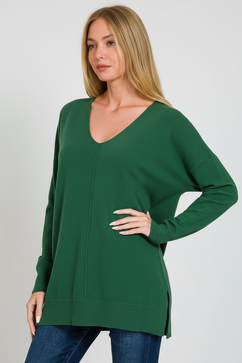 Woman wearing a dark green  front center seam sweater on a white background