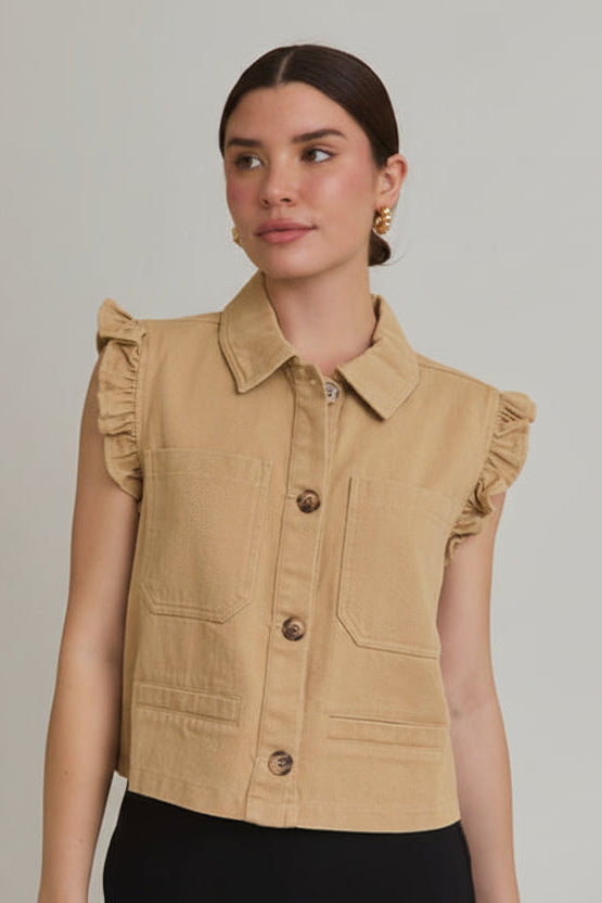 Woman wearing taupe ruffle detail button down collar jean vest on beige  background