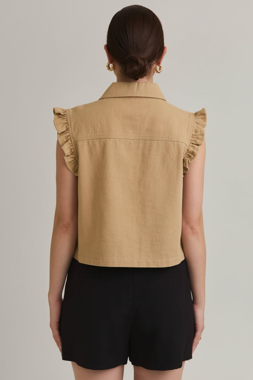 Back view of a woman wearing taupe ruffle detail button down collar jean vest with black skirt on beige  background