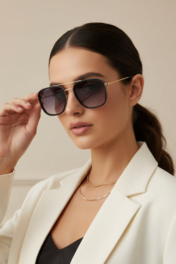 Woman wearing square black and metal sunglasses on white background