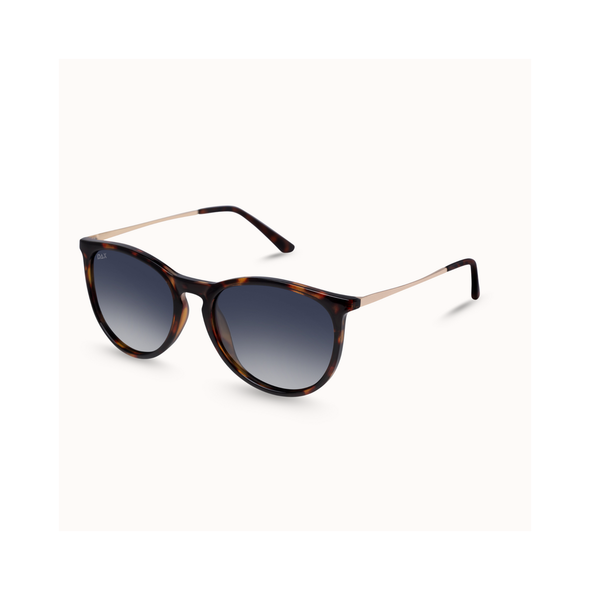 Tortoiseshell sunglasses with a gradient gray lens and slim gold metal temples, shown on a clean off-white background.