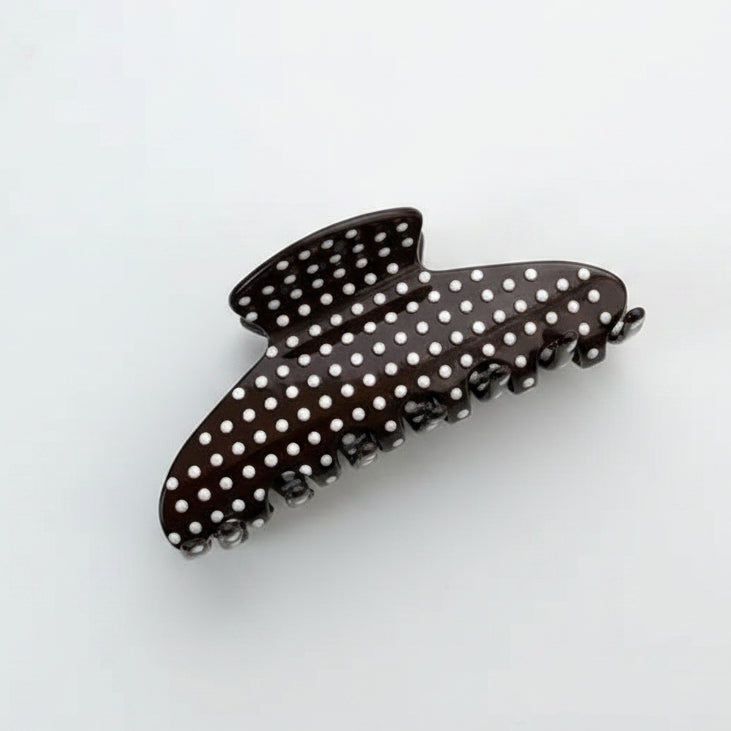 Dark brown hair claw with pink dots on white background