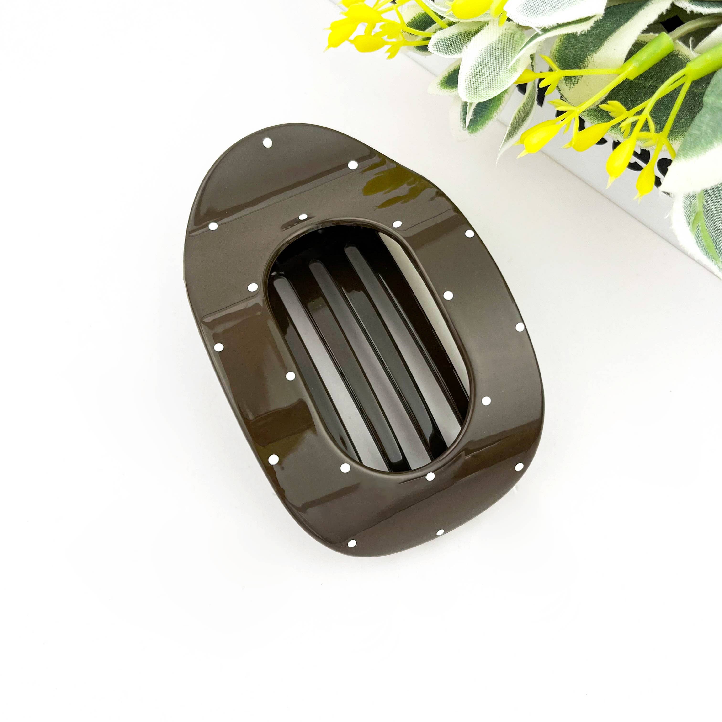 Brown polka dot flat hair clip on white background