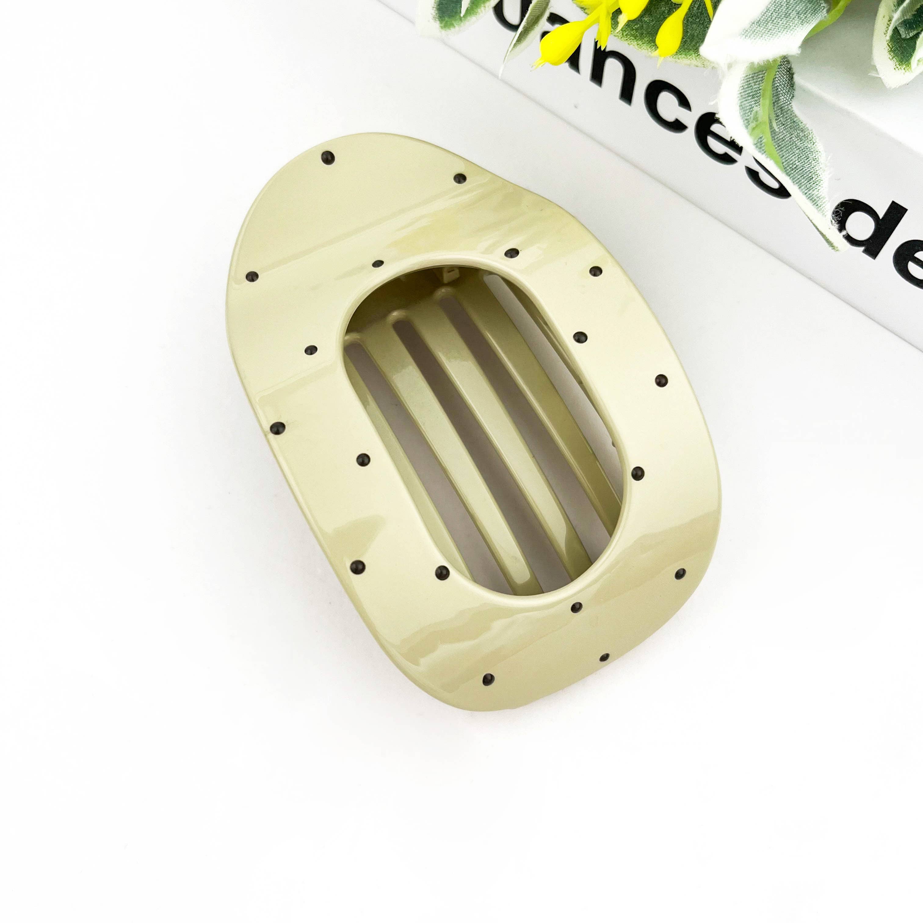 White polka dot flat hair clip on white background