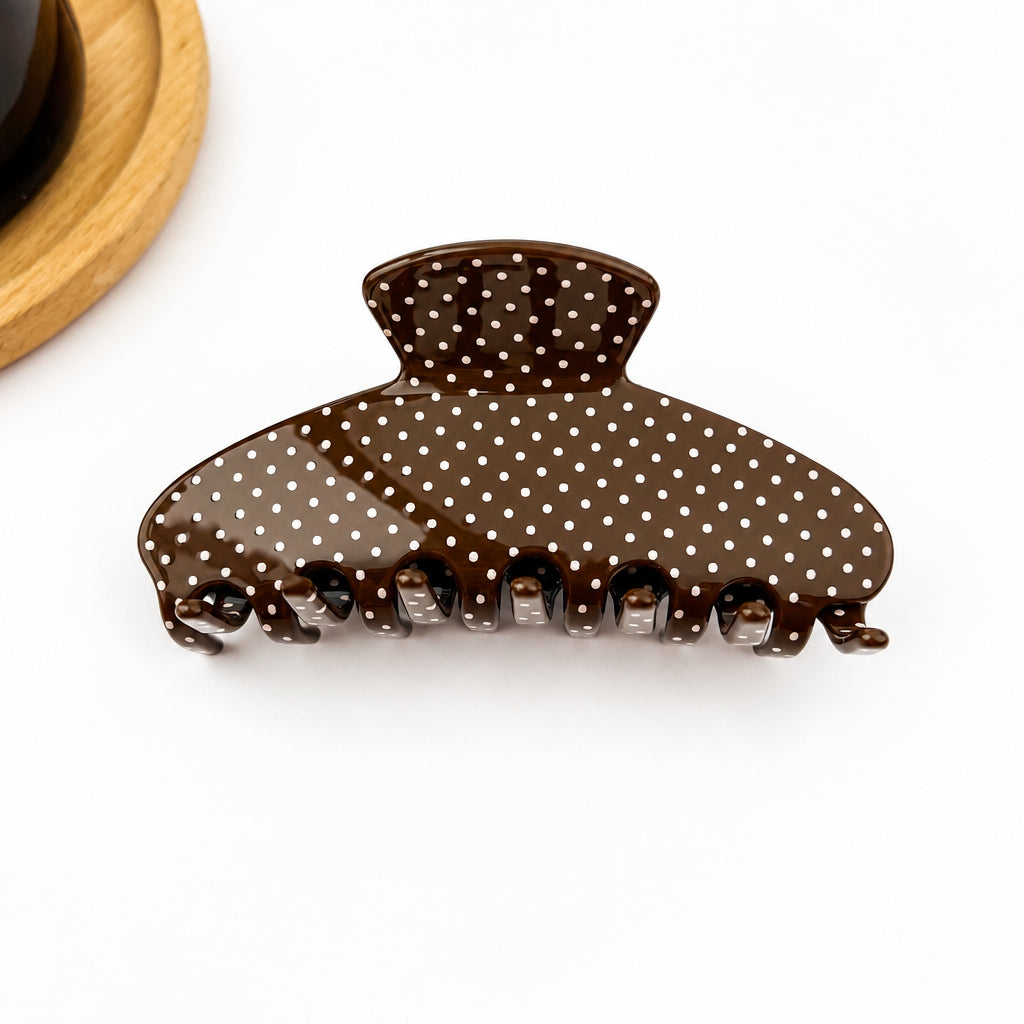 Brown hair claw with tan polka dots on a white background 