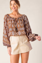 Women's abstract print drawstring neckline top with blouson sleeves