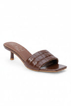 Brown croc detail slip on slide with a kitten heel on a white background
