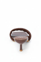 Brown ceramic teapot with wooden handle on a white background