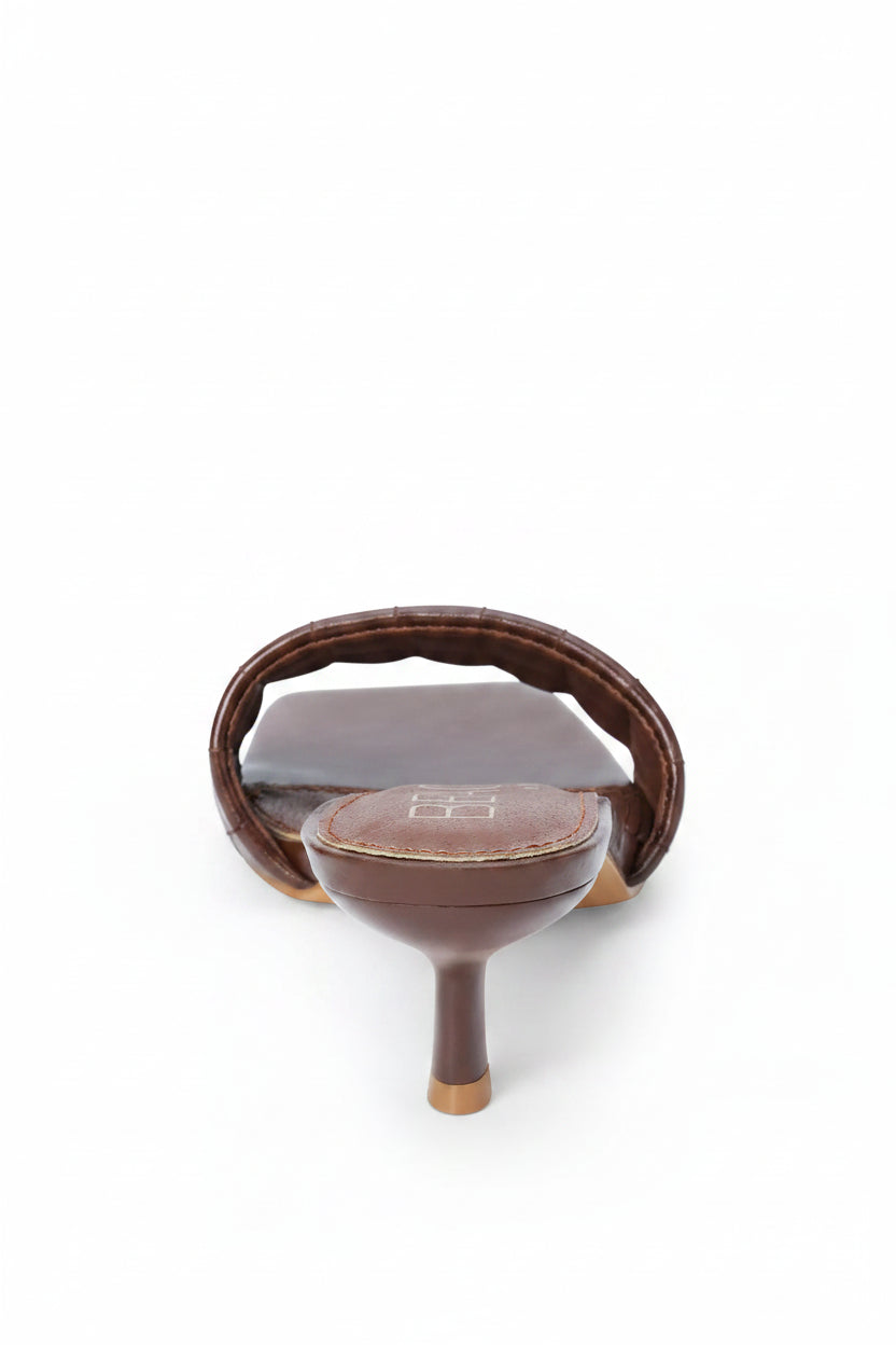 Brown ceramic teapot with wooden handle on a white background