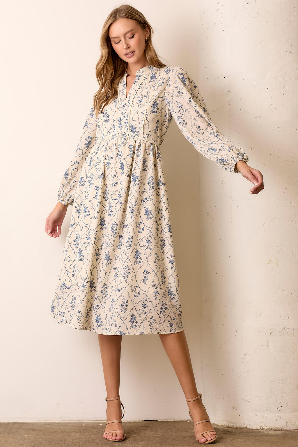 Woman wearing floral maxi dress against a white background