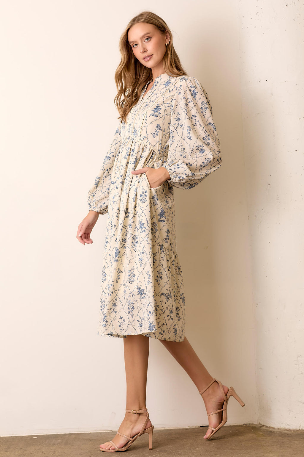 Woman wearing floral maxi dress against a white background