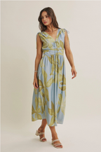 Woman wearing a floral dress on a plain background