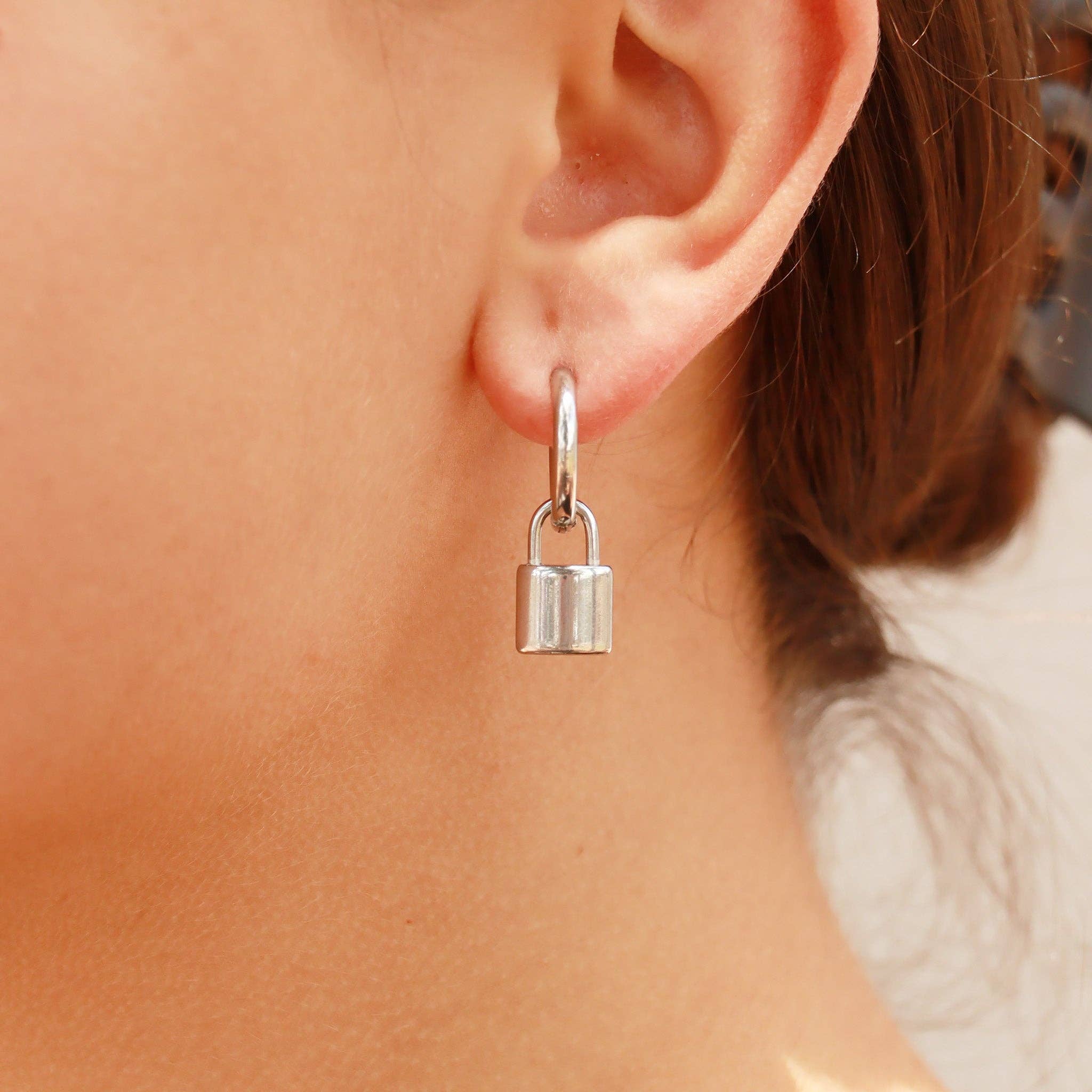Woman wearing silver padlock earrings 