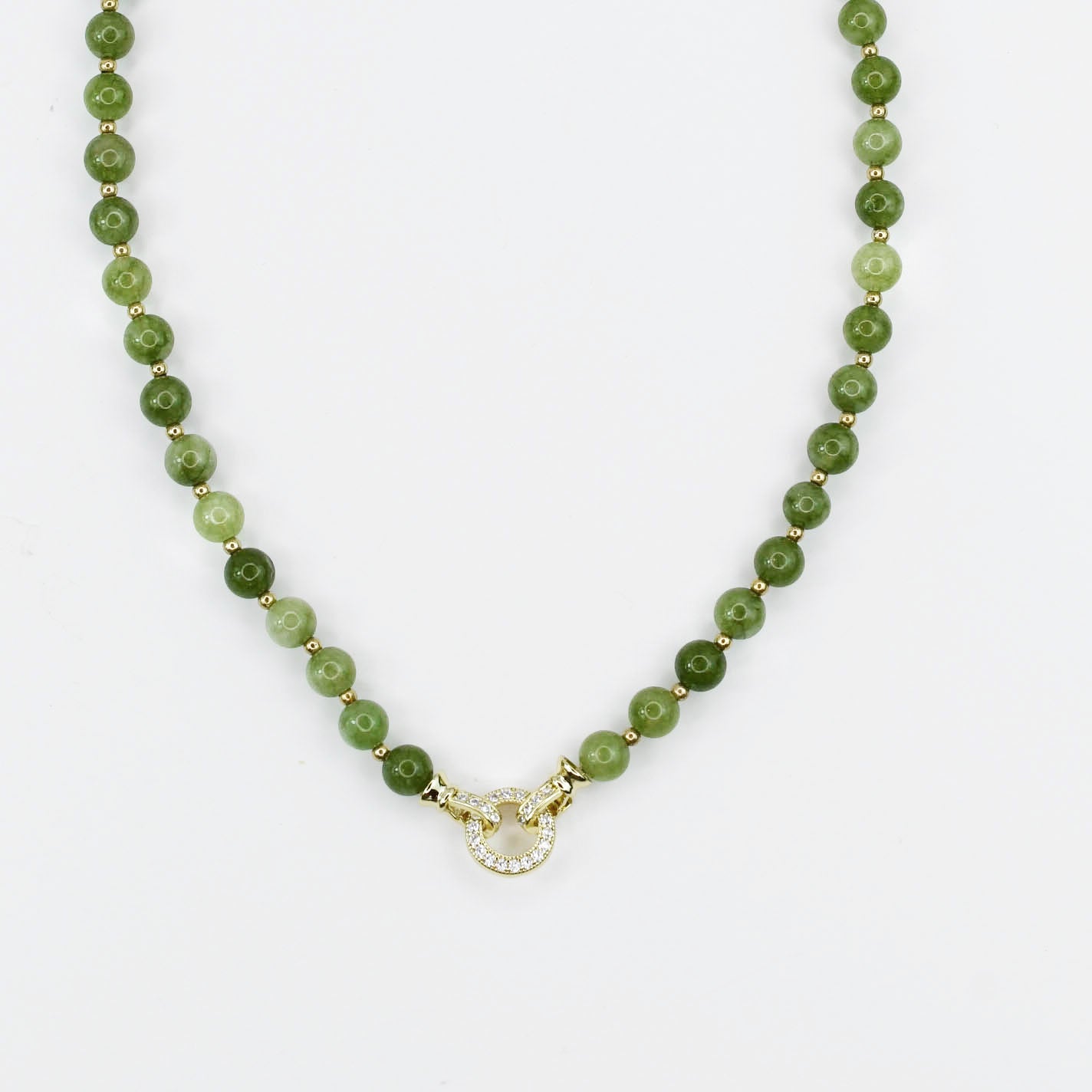 Green beaded gemstone necklace with a gold CZ clasp on a white background