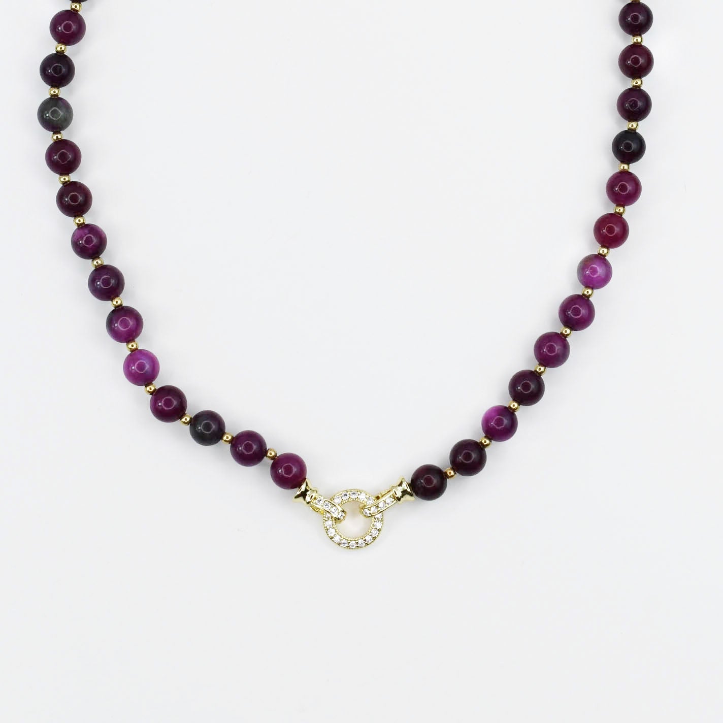 Necklace with maroon gemstone  beads and a gold CZ clasp on a white background