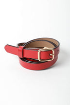 Red leather belt with a gold buckle on a white background