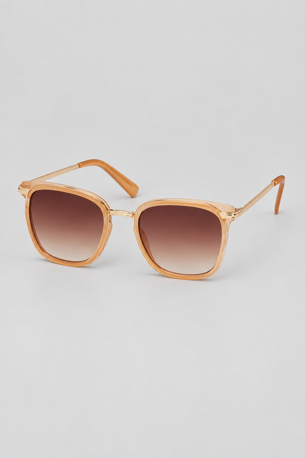 Tan frame with metal side arm sun glasses with brown lens against a white background