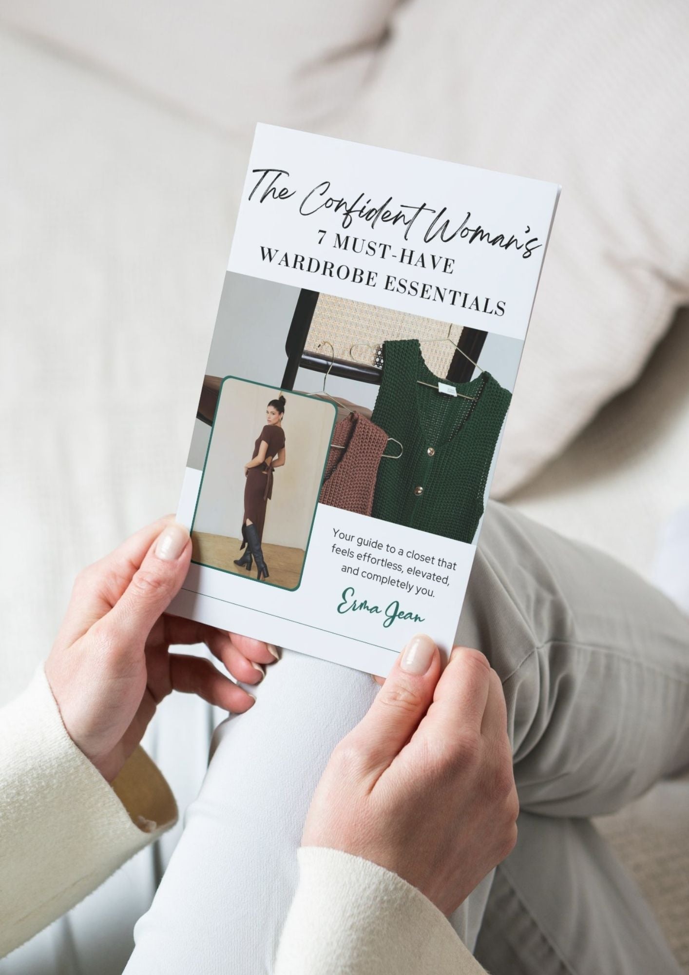 Person holding a book titled 'The Confident Woman's Wardrobe Essentials' by Erma Jean.