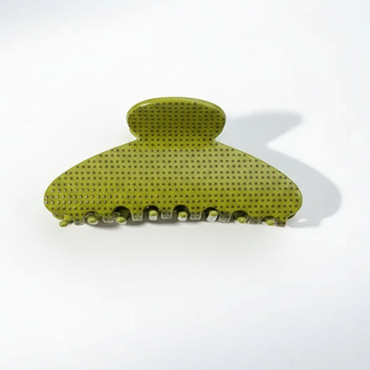 An olive green claw hair clip with rust color dots displayed on a white background