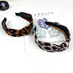 Women's two leopard print top knot headbands on a white surface