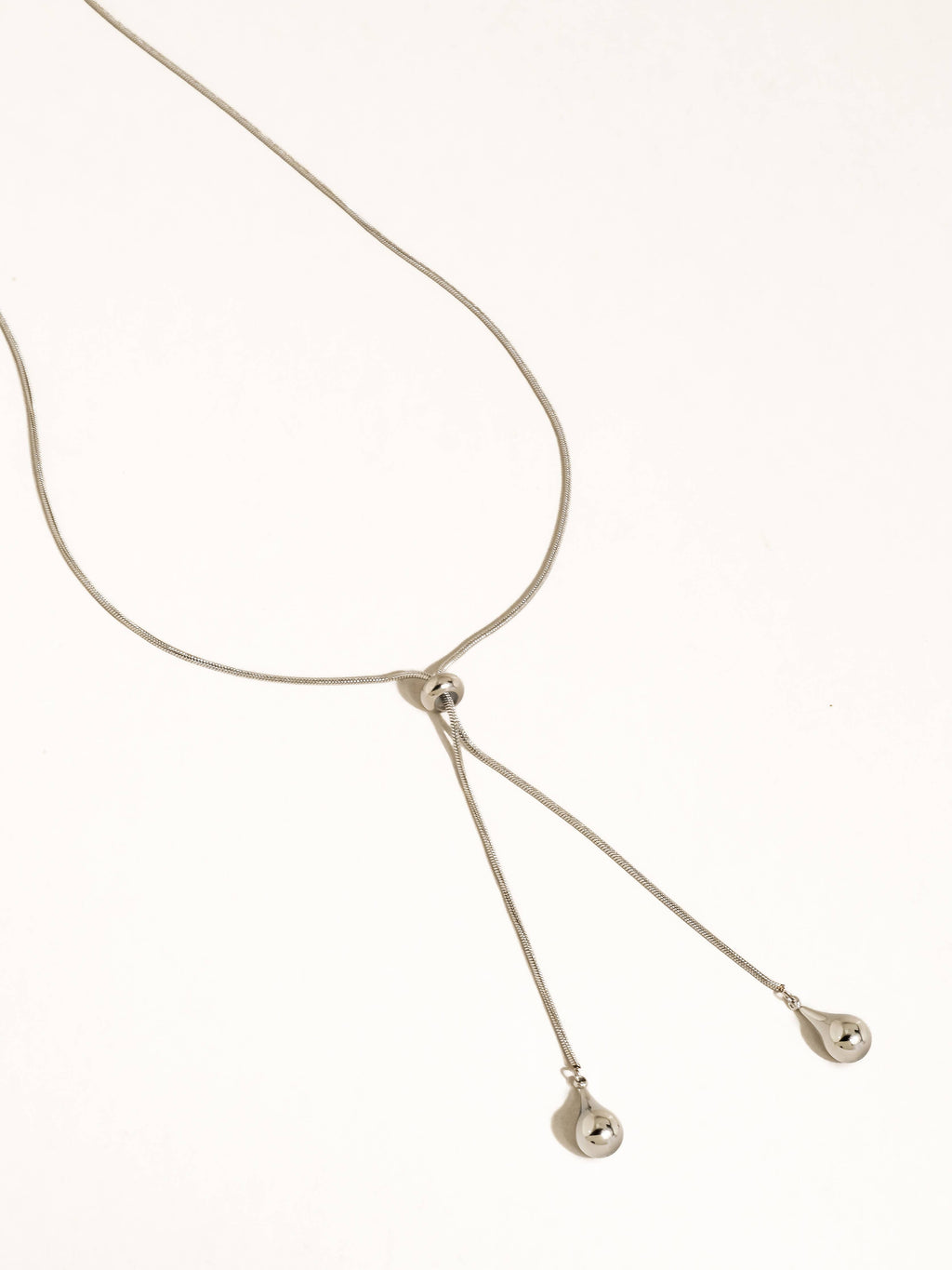 A silver-plated adjustable lariat style teardrop pendant necklace shown on a plain white background.