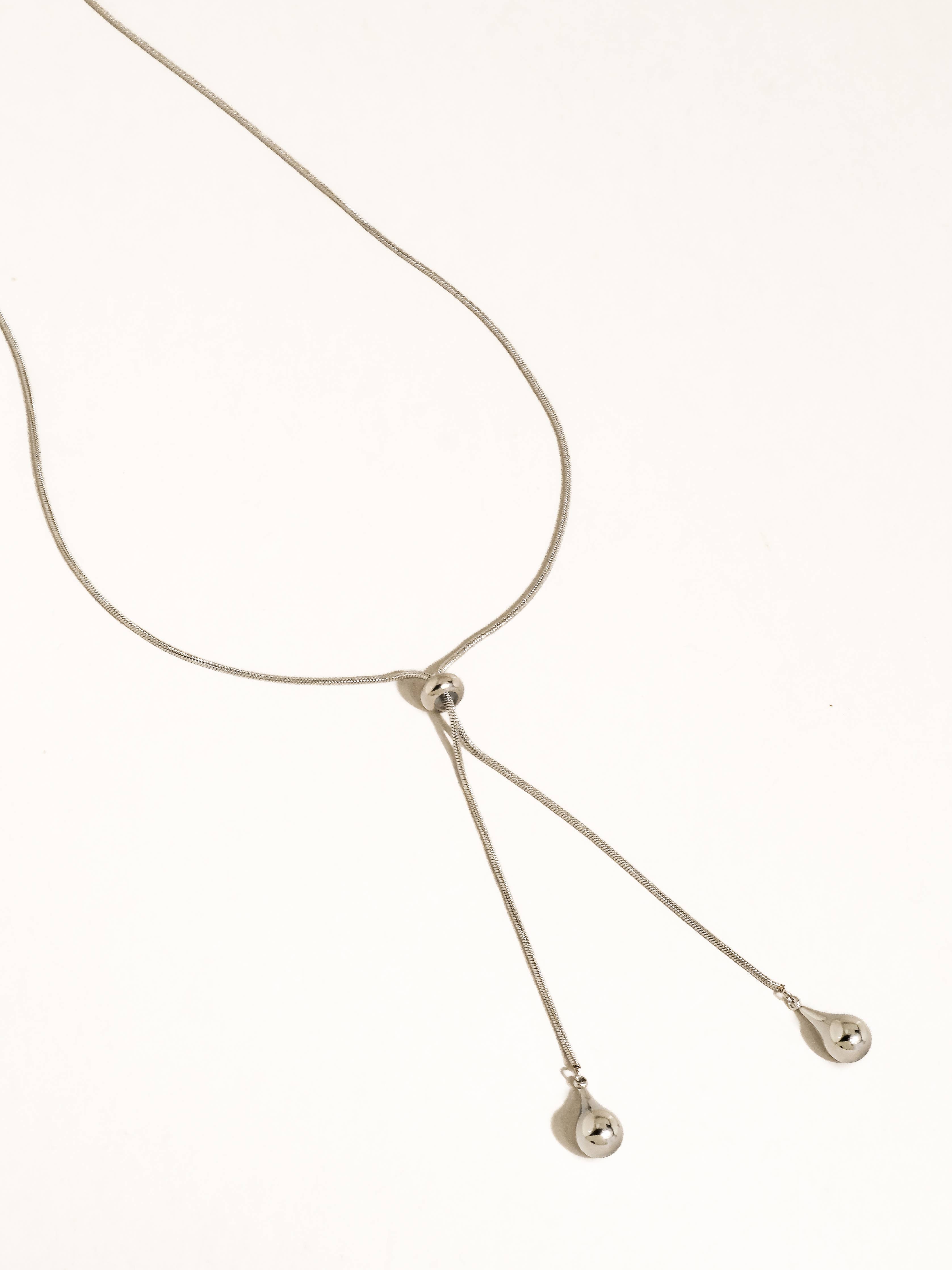 A silver-plated adjustable lariat style teardrop pendant necklace shown on a plain white background.