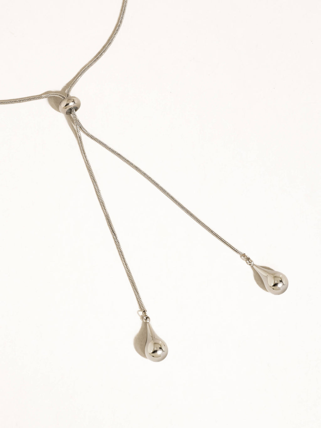 A silver-plated adjustable lariat style teardrop pendant necklace shown on a plain white background.