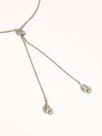 A silver-plated adjustable lariat style teardrop pendant necklace shown on a plain white background.