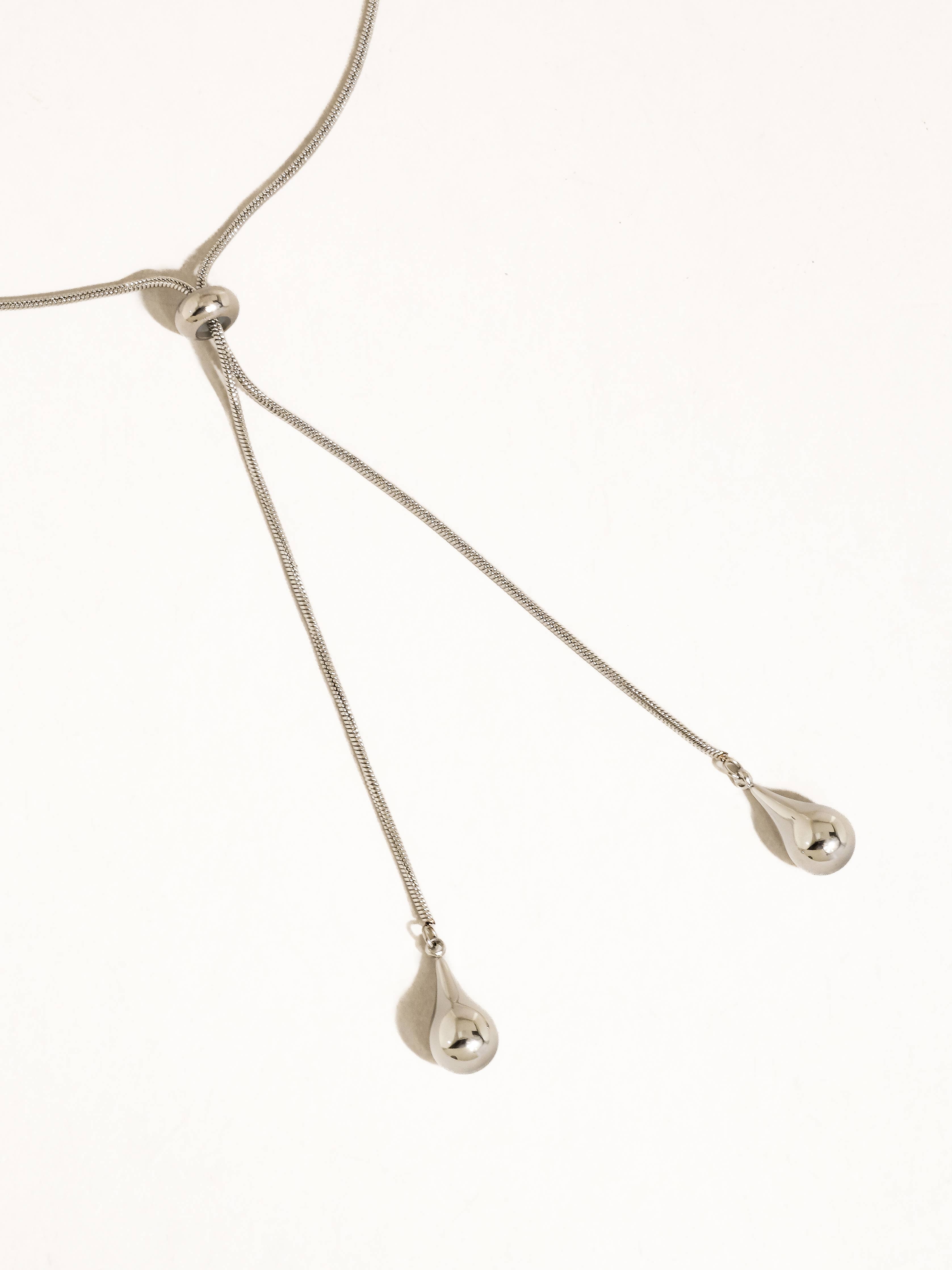 A silver-plated adjustable lariat style teardrop pendant necklace shown on a plain white background.