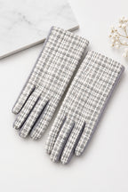 Gray and white tweed woven hand gloves on a white background