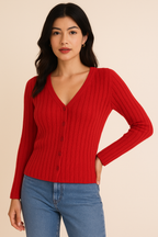 Woman wearing a berry ribbed knit button front sweater and blue jeans on a beige background