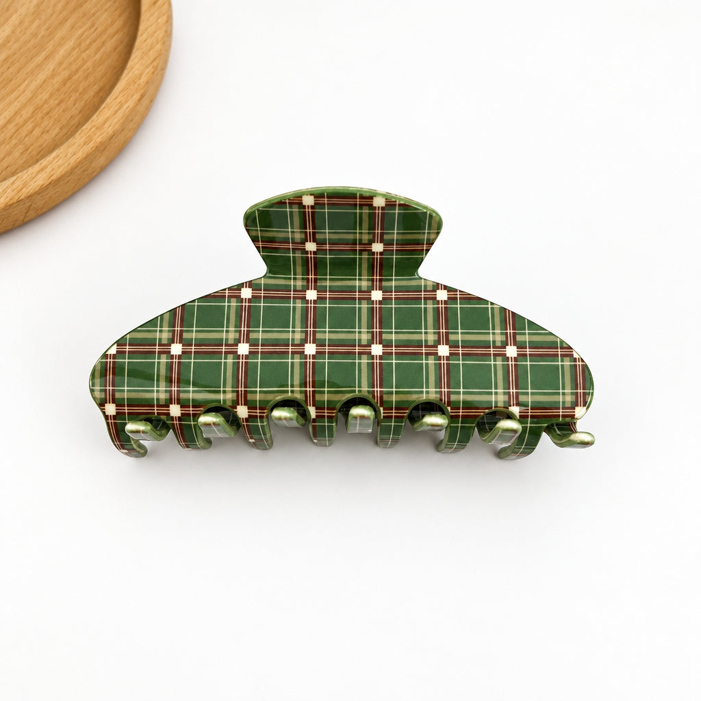 Green plaid hair clip on a white background