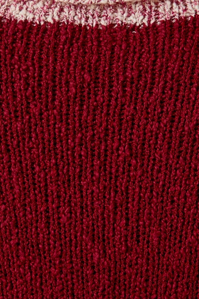 Close up of textured berry knit sweater with cream contrast trim 