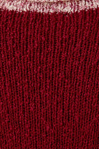 Close up of textured berry knit sweater with cream contrast trim 