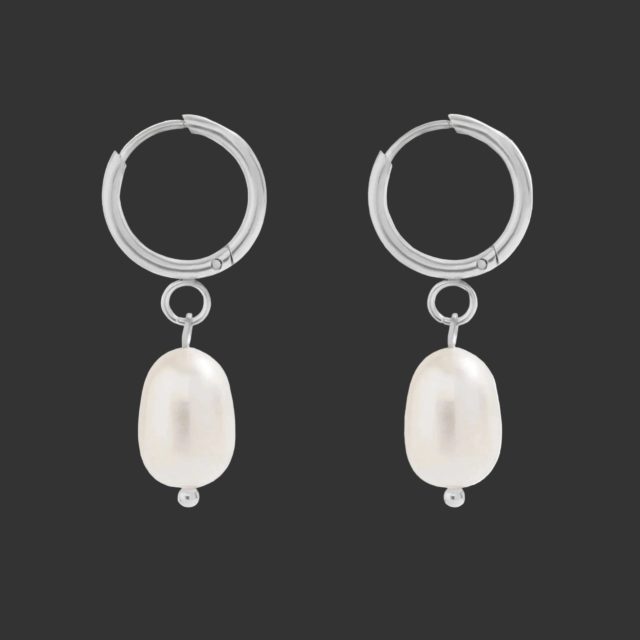 Stsainless steel huggie earrings with freshwater pearl drop on a white background