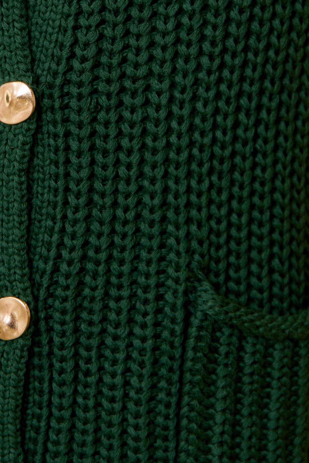 Close-up of green chunky knit and gold textured buttons